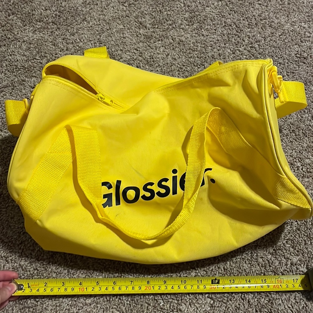 Glossier yellow duffel bag